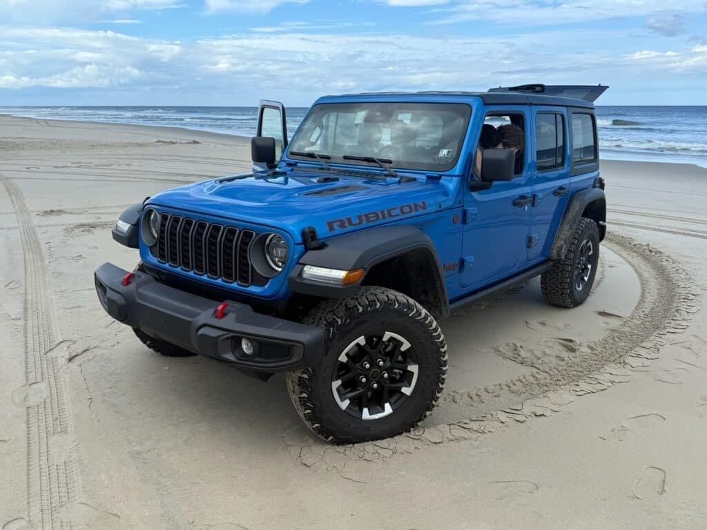 Blue Jeep Wrangler Rubicon parked on the sand at the Corolla 4x4 beach